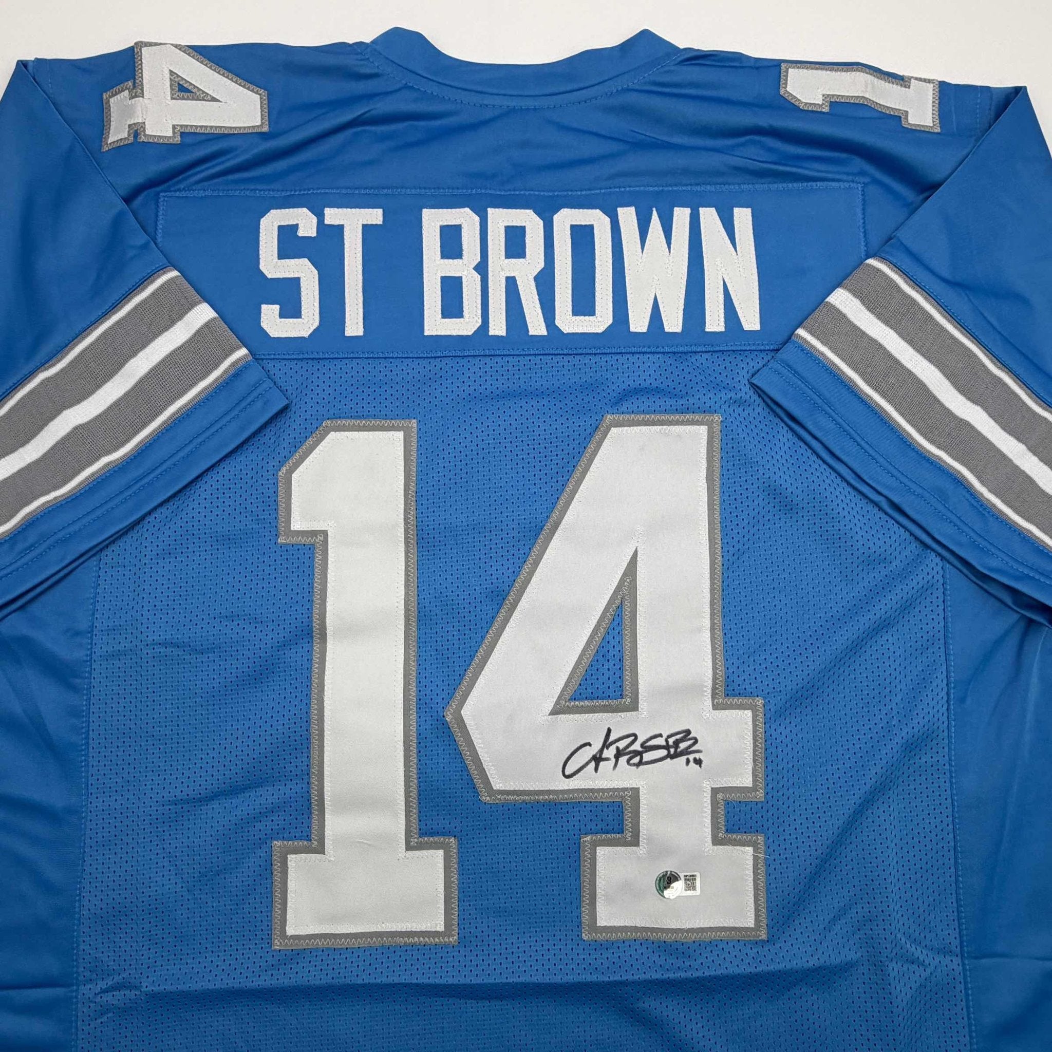 Autographed/Signed Amon-Ra St. Brown Detroit Current Blue Football Jersey Beckett BAS COA